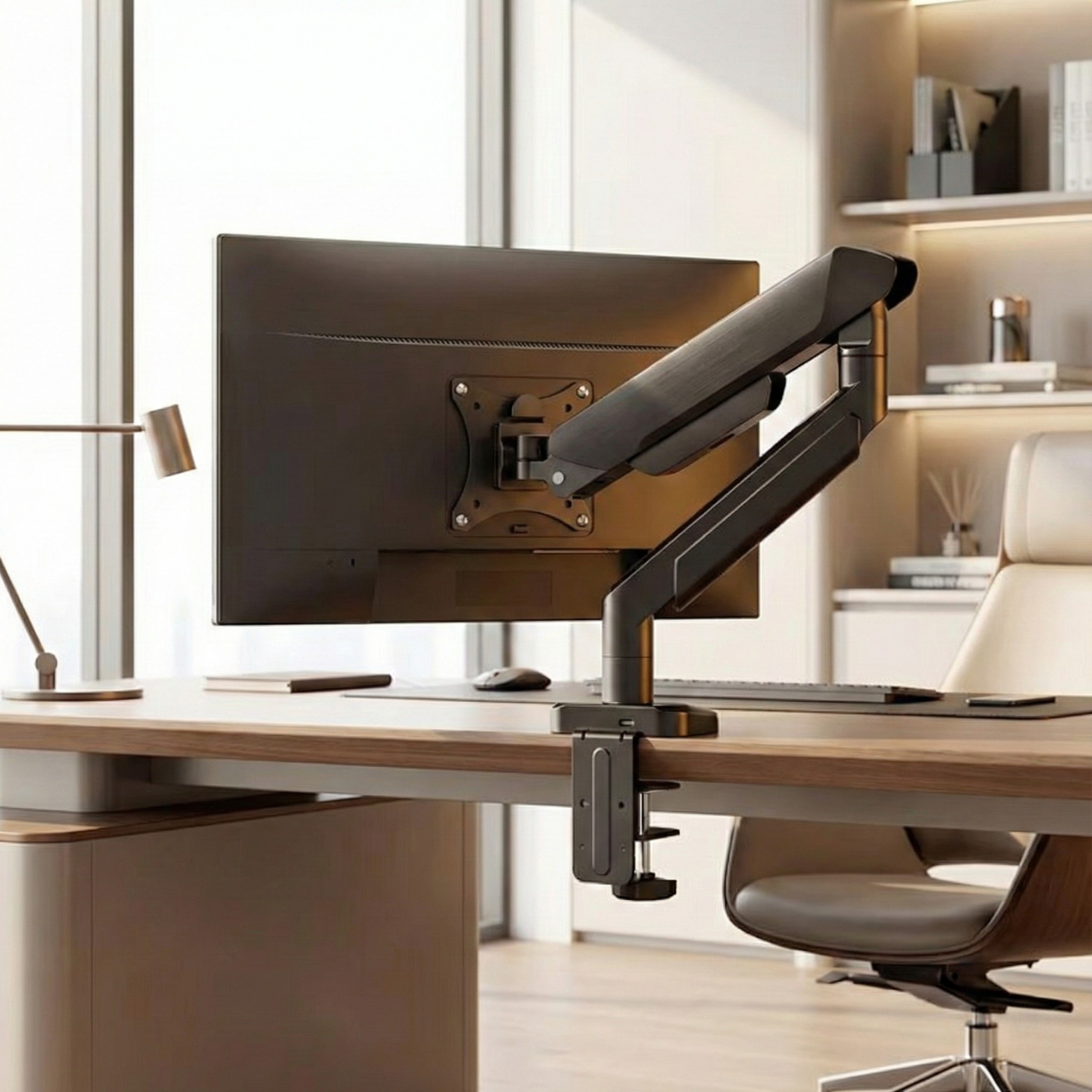 Deskon monitor holder on a desk in a real office, seen from behind