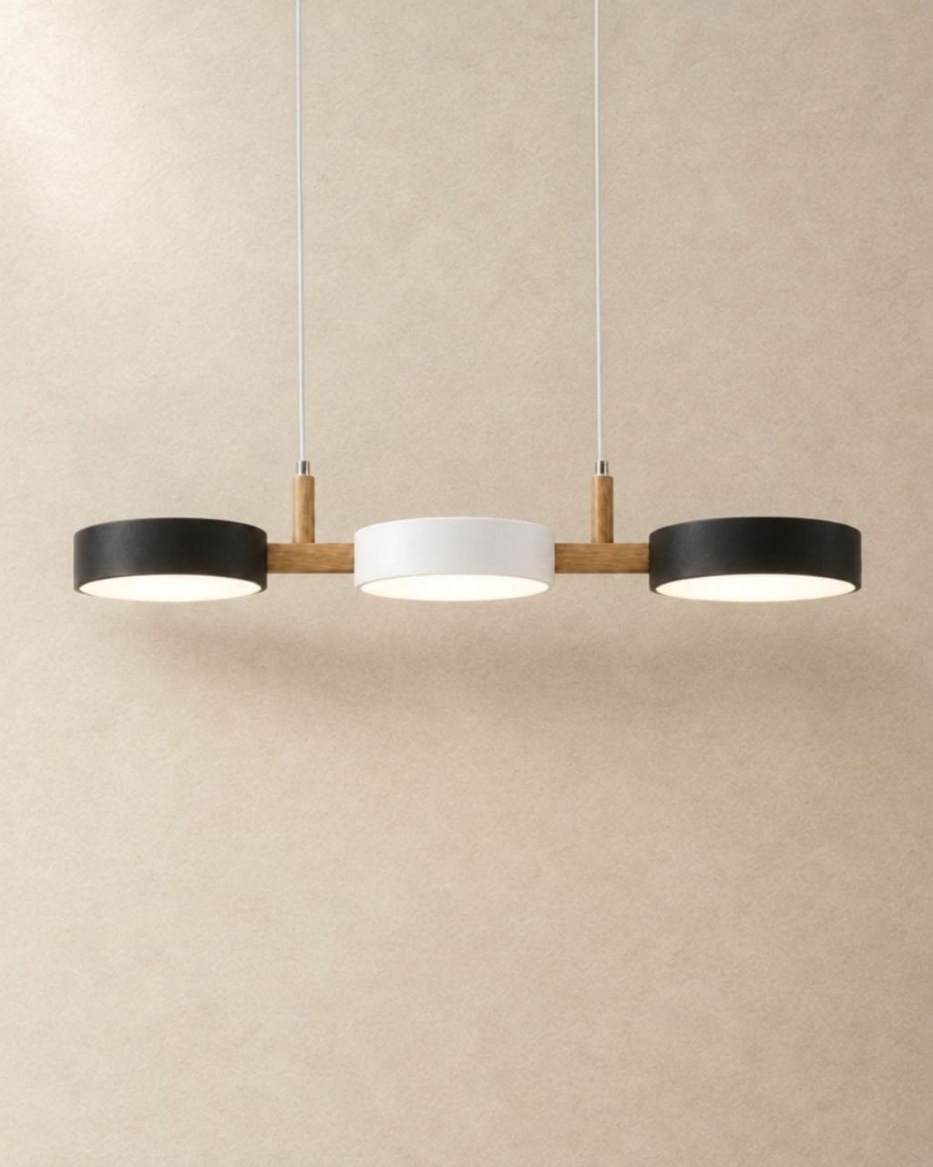 Brant pendant light in black, white and black, three fixtures, product photograph