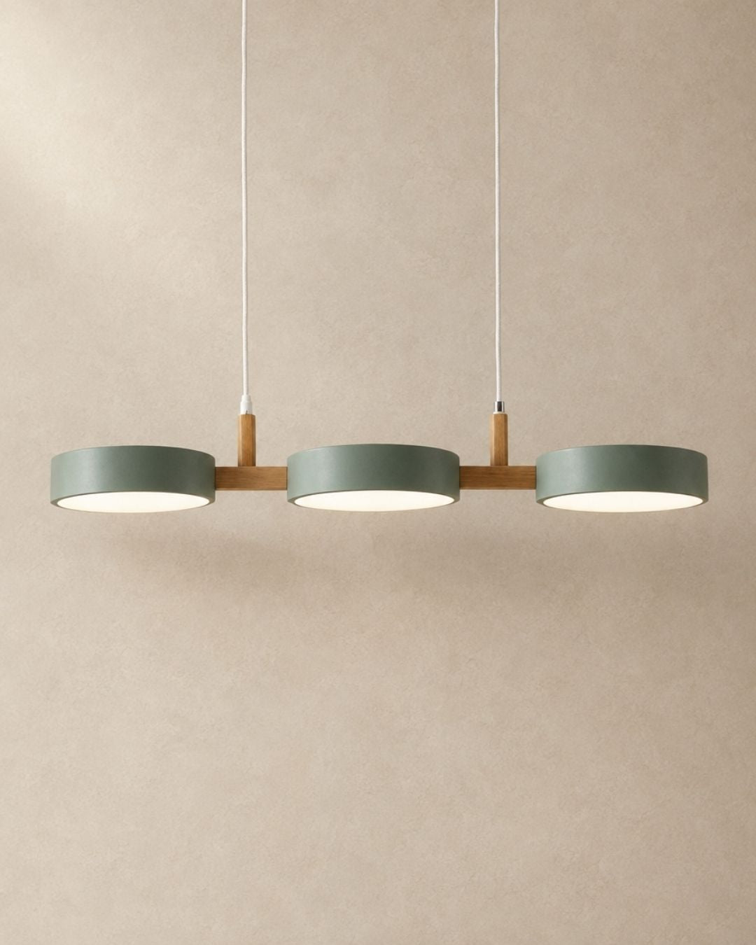 Brant pendant light in green, three fixtures, product photograph