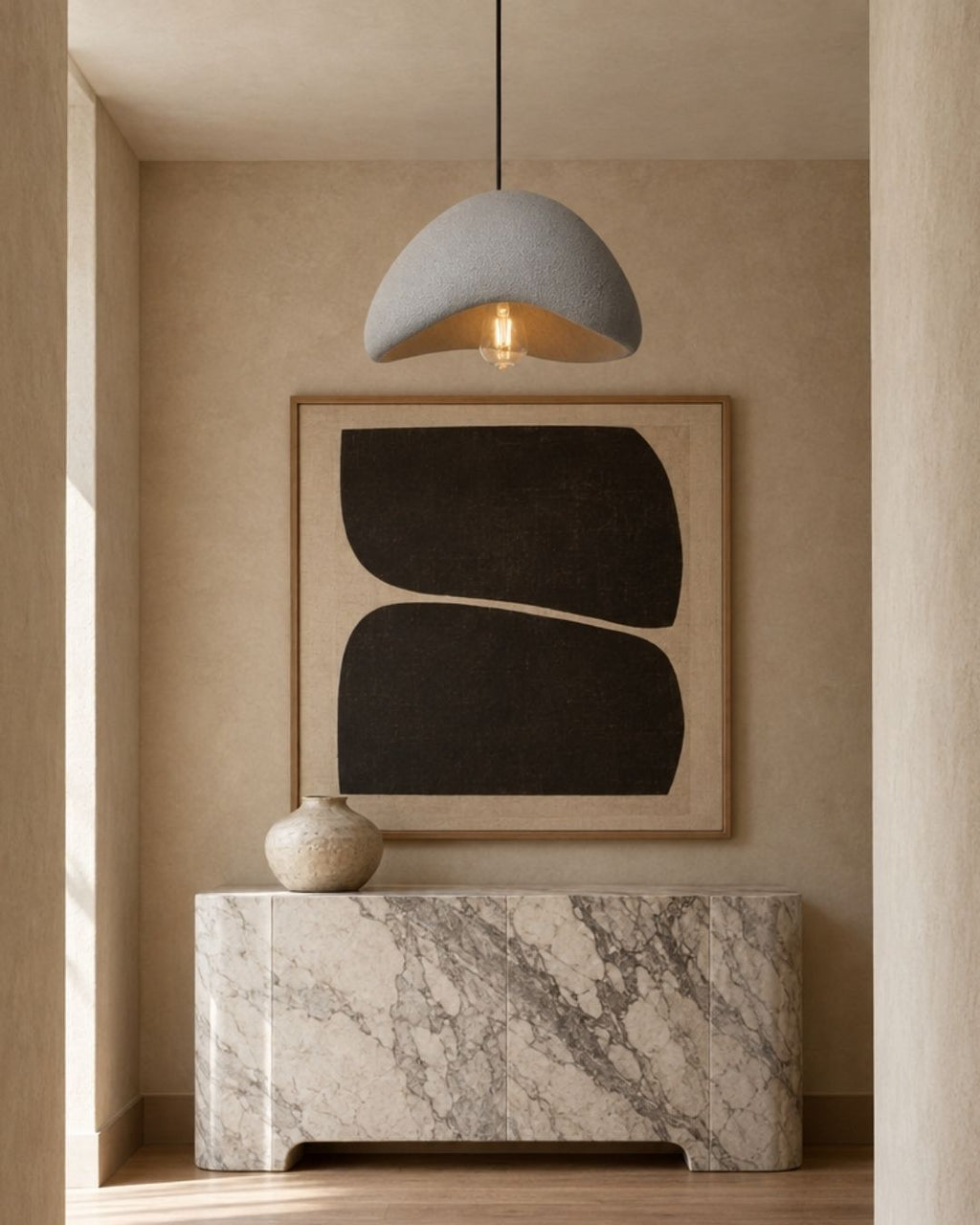 Desna pendant light in grey, wavy silhouette, in a hallway with marble and artwork