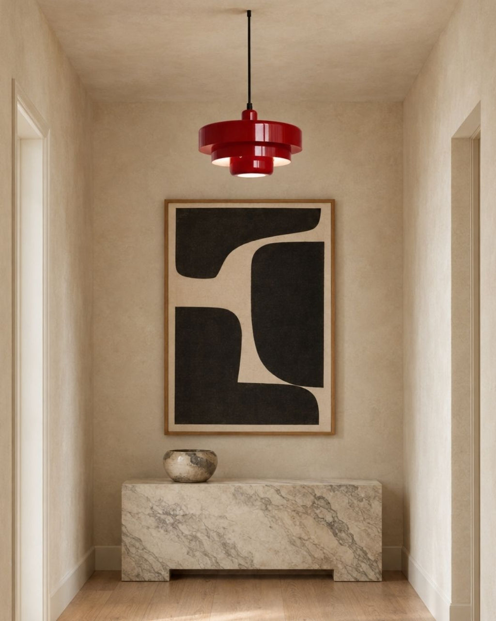 Tessia pendant light in red, hanging in a hallway above a sideboard with artwork