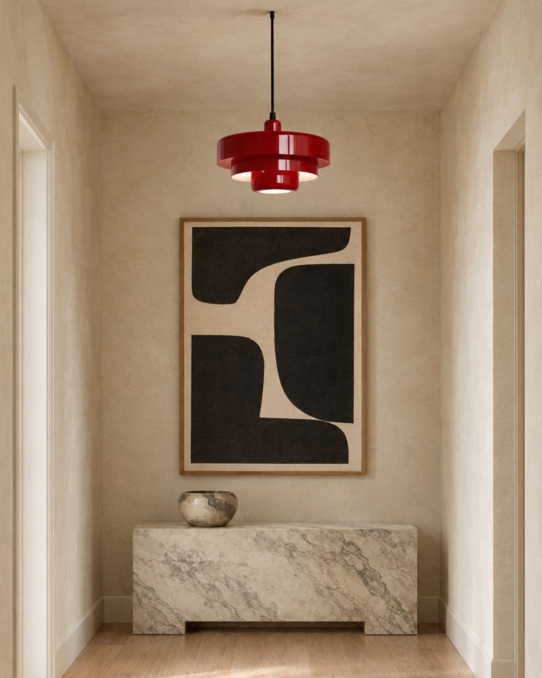 Tessia pendant light in red, hanging in a hallway above a sideboard with artwork
