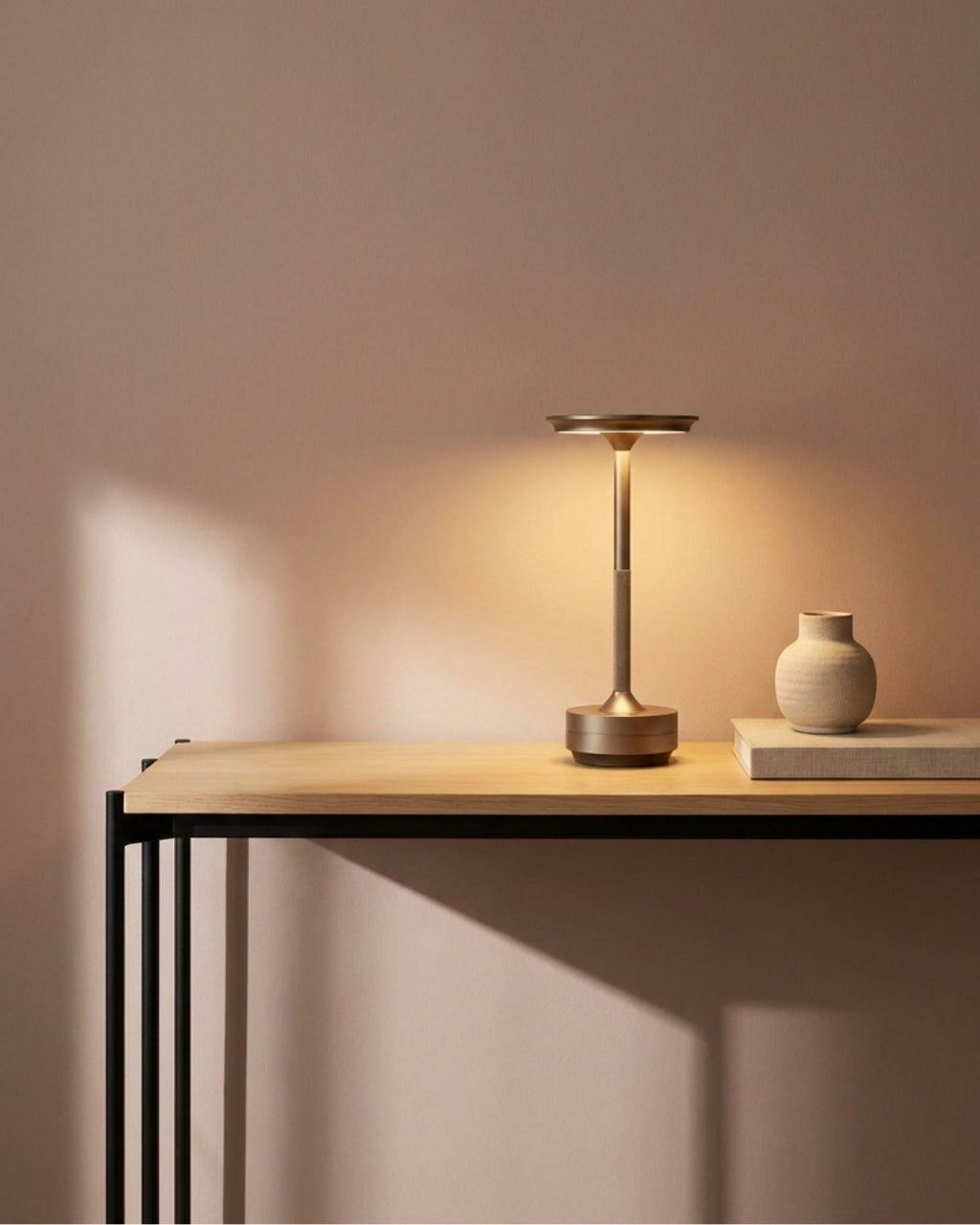 Brenna table lamp in silver lit on a console in a living room