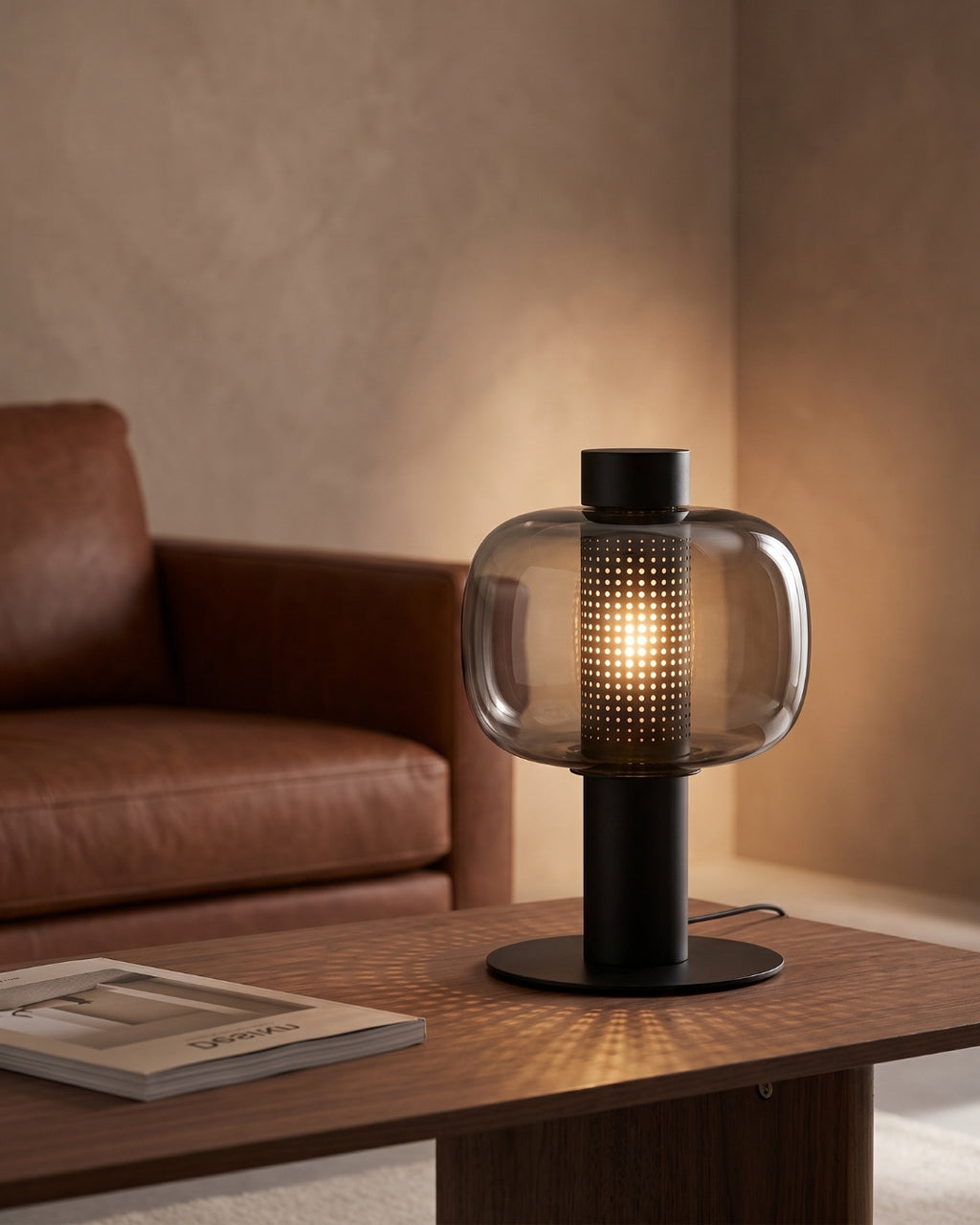Breva table lamp in black lit on a wooden coffee table