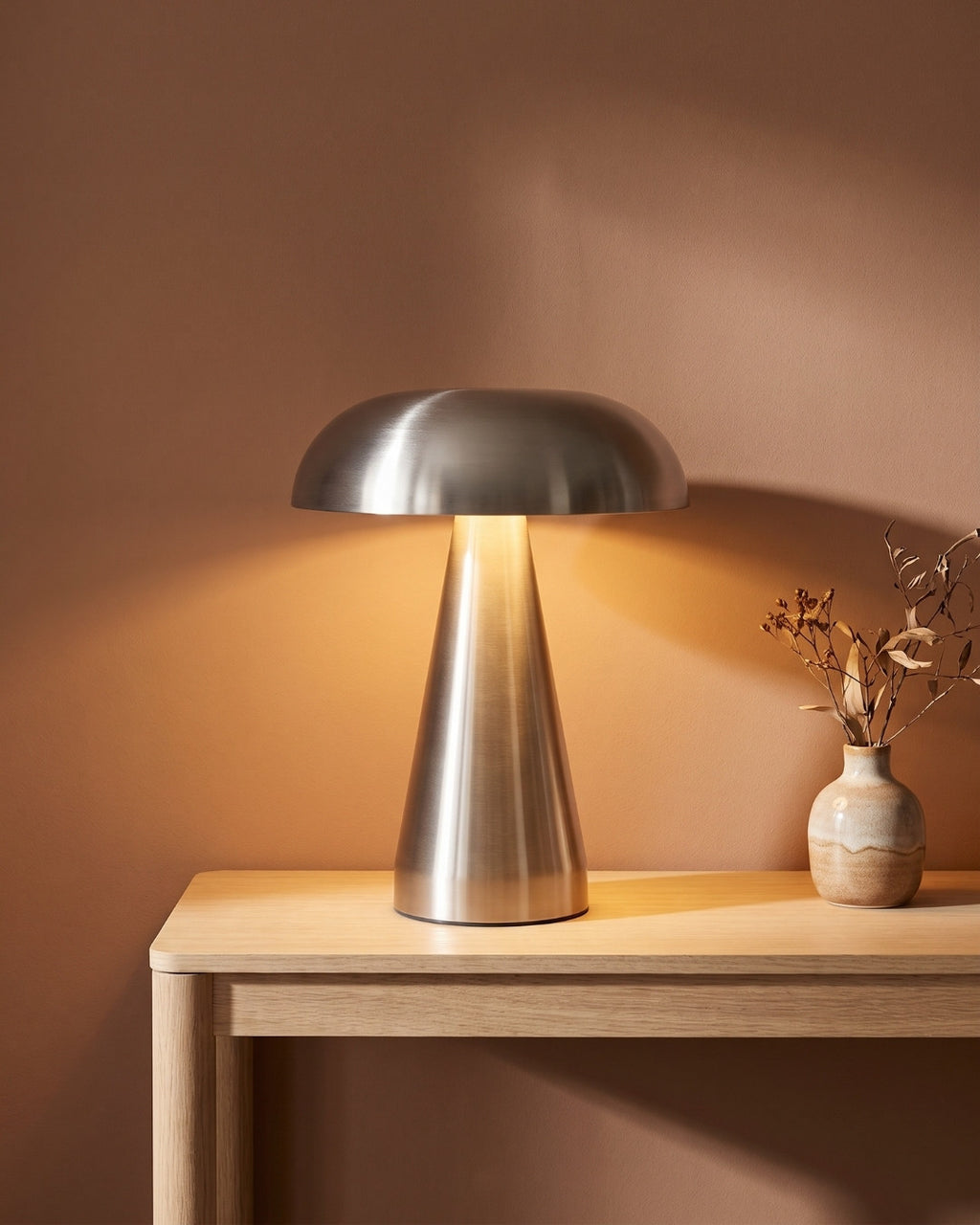 Cerlin table lamp in silver lit on a slim console