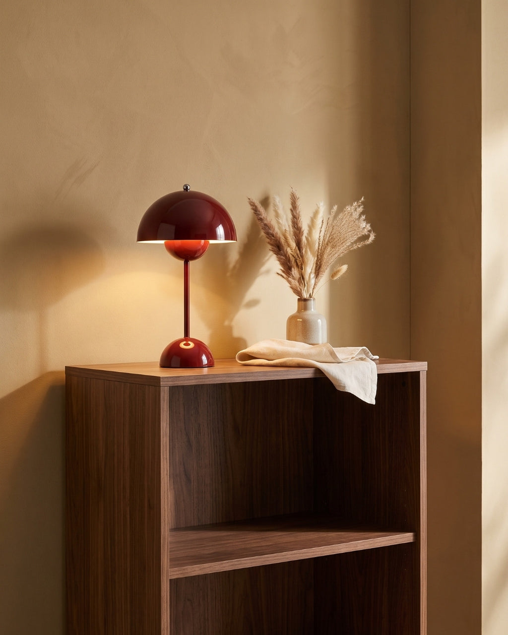 Elsin table lamp in red on an open shelving unit