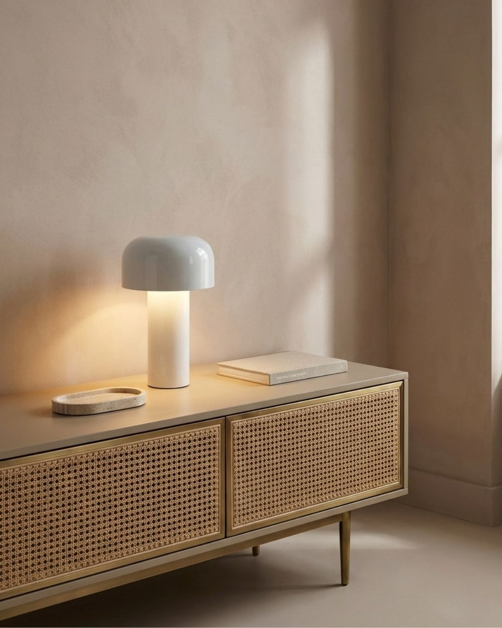 Halo table lamp in white lit on a wooden console in a living room