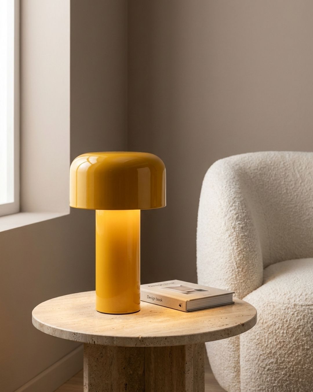 Halo table lamp in yellow lit on a side table beside a sofa