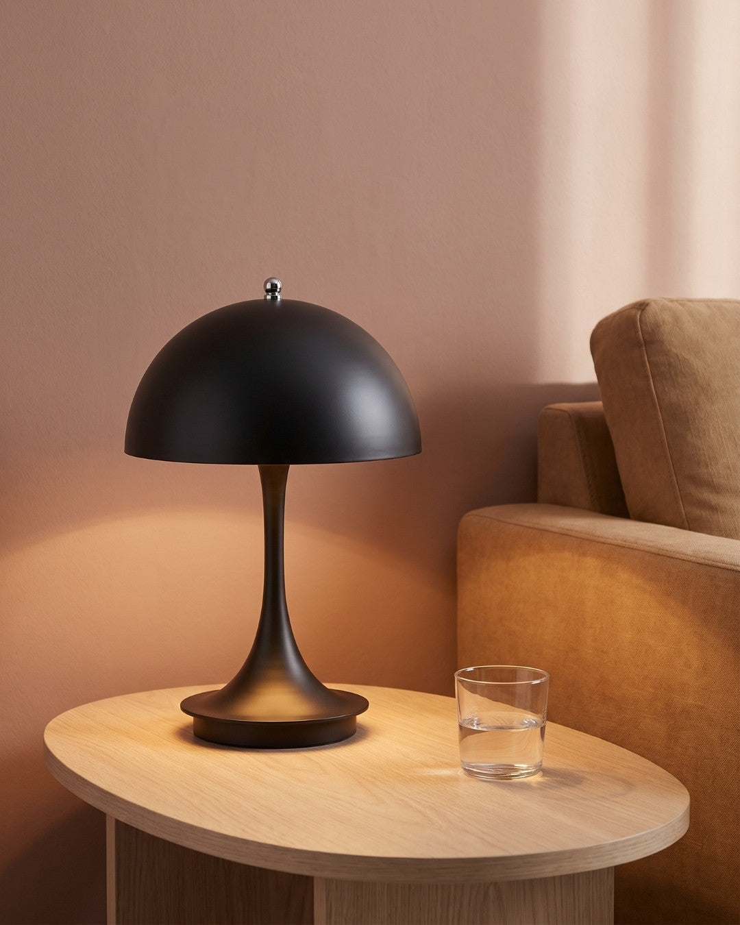 Harvo table lamp in black lit on a wooden side table