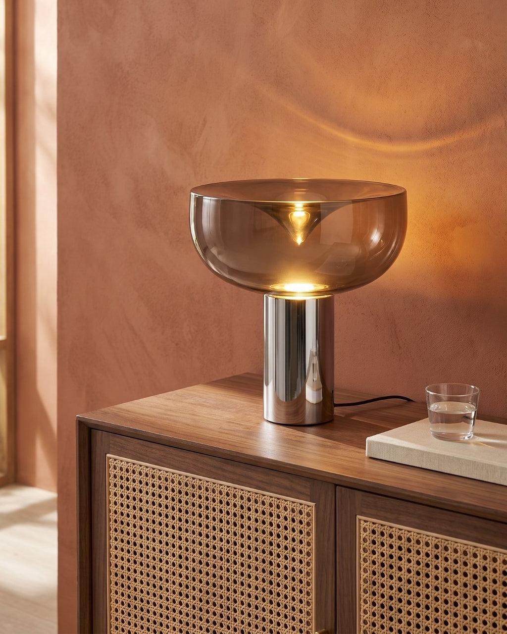 Marla table lamp in black lit on a sideboard in a living room