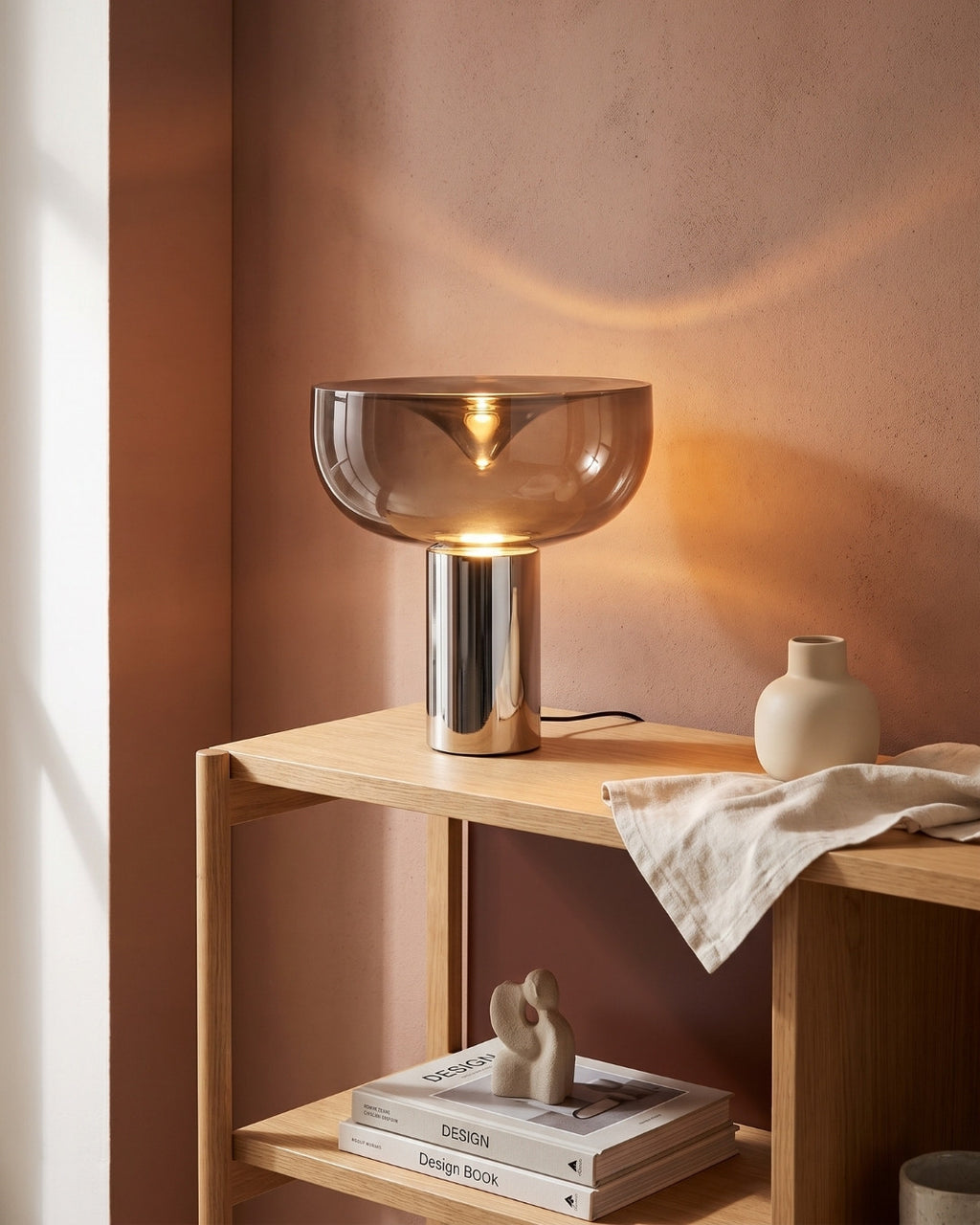 Marla table lamp in black lit on a slim console in a living room