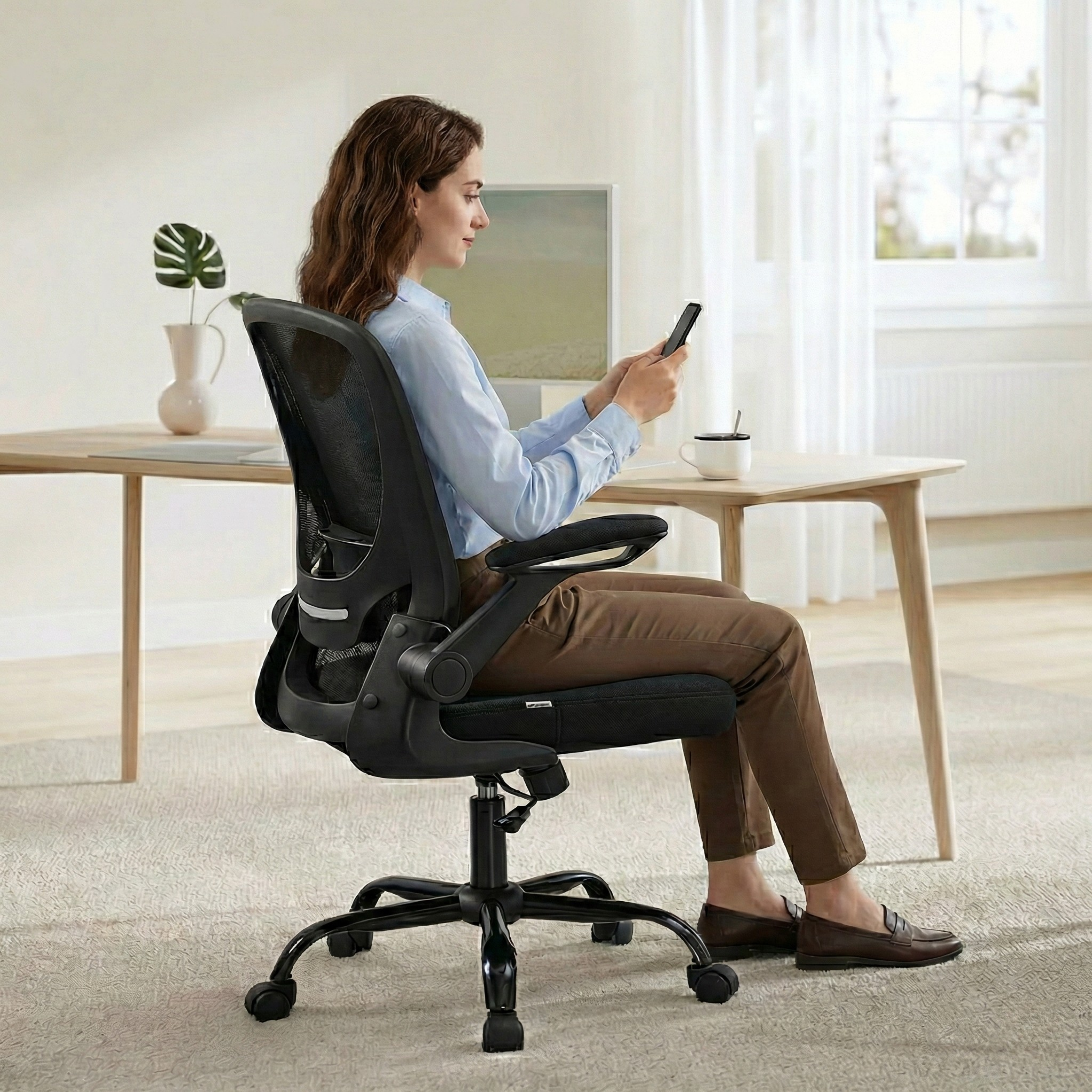 a woman sitting on deskon office chair 